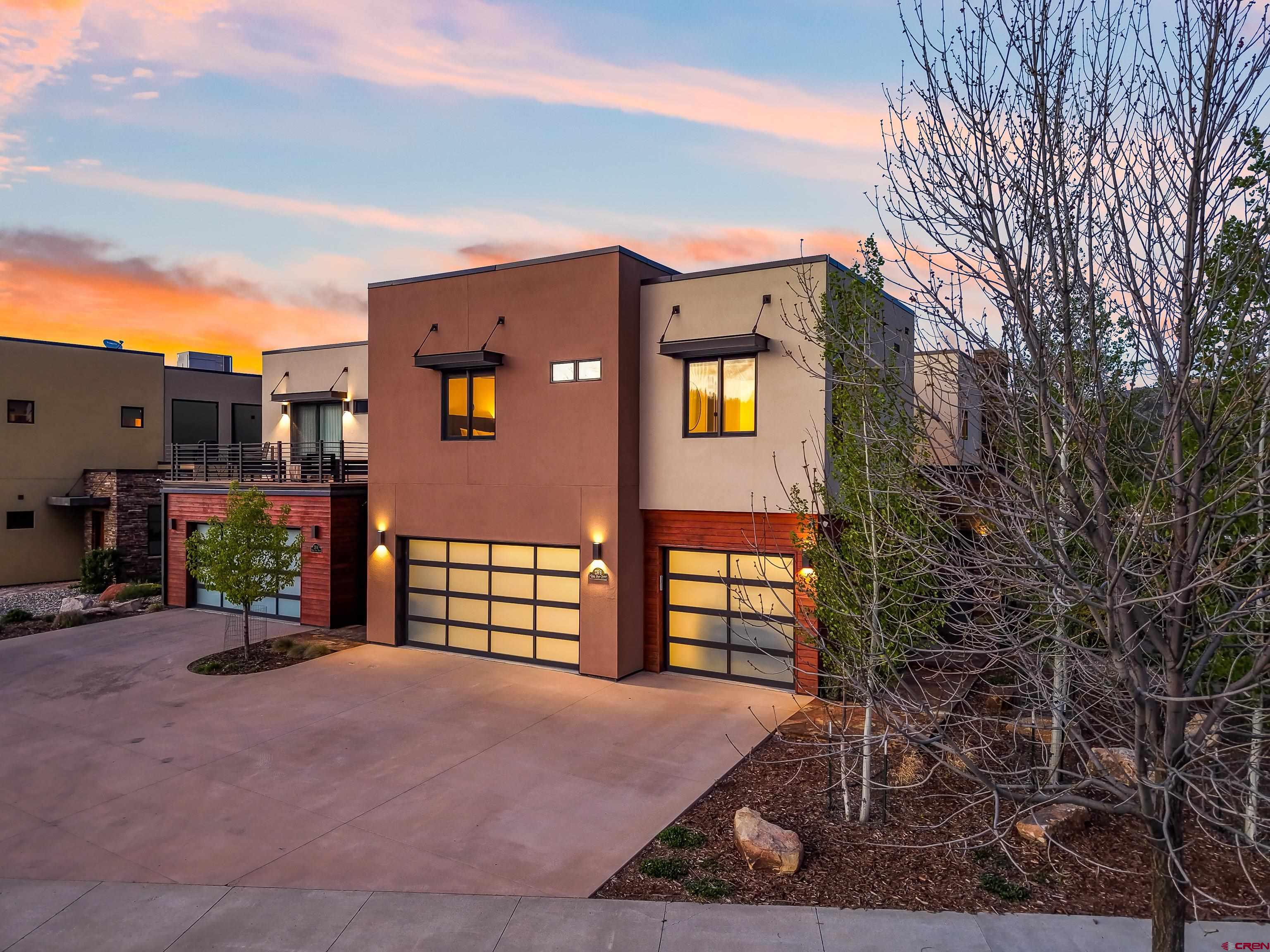 239 Rock Point Drive, Unit B Durango, CO 81301 - Photo 6 of 45 a front view of a house with a yard and garage