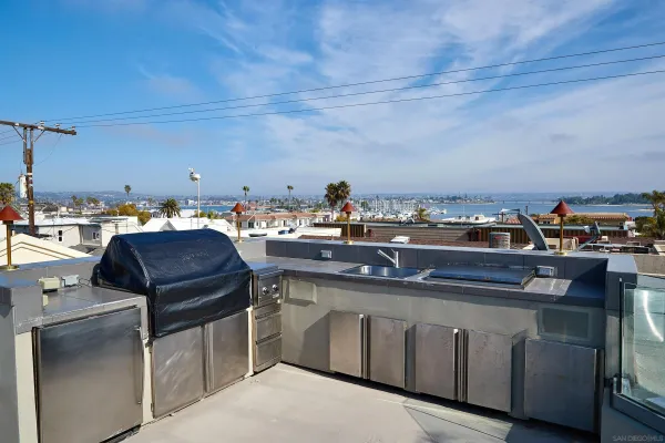 a roof deck with patio table and chairs