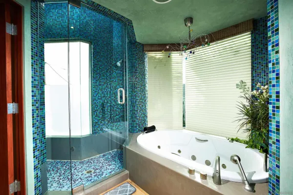 a bedroom with a large bed and a chandelier