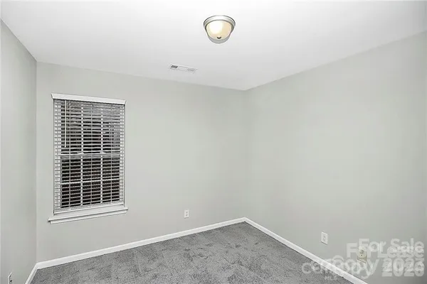 a view of an empty room with windows