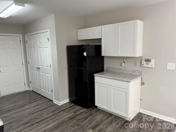a kitchen with a refrigerator sink and cabinets