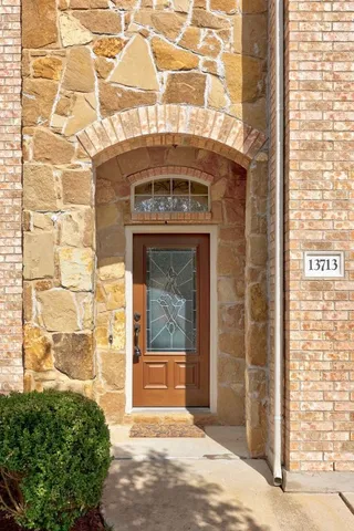 a view of an empty room with a window and fireplace