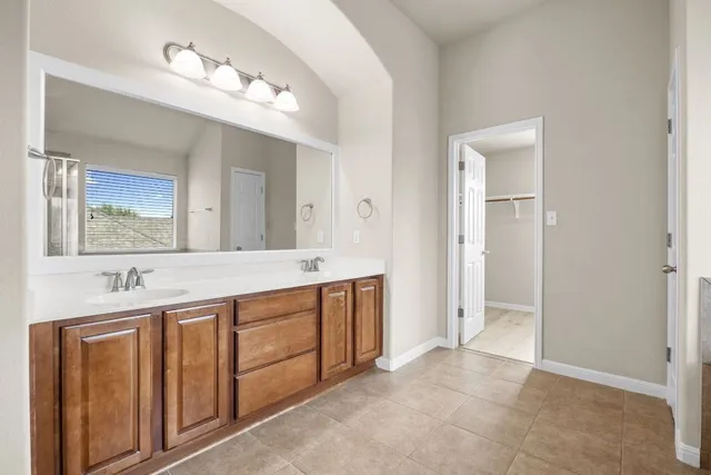 a white bath tub sitting next to a shower