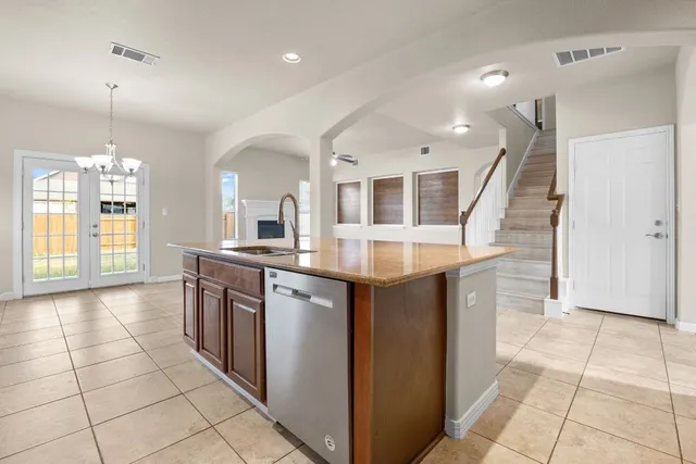 a kitchen with stainless steel appliances granite countertop a refrigerator a sink and a stove