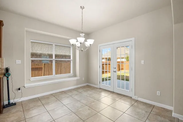 a view of a kitchen with refrigerator and chandelier