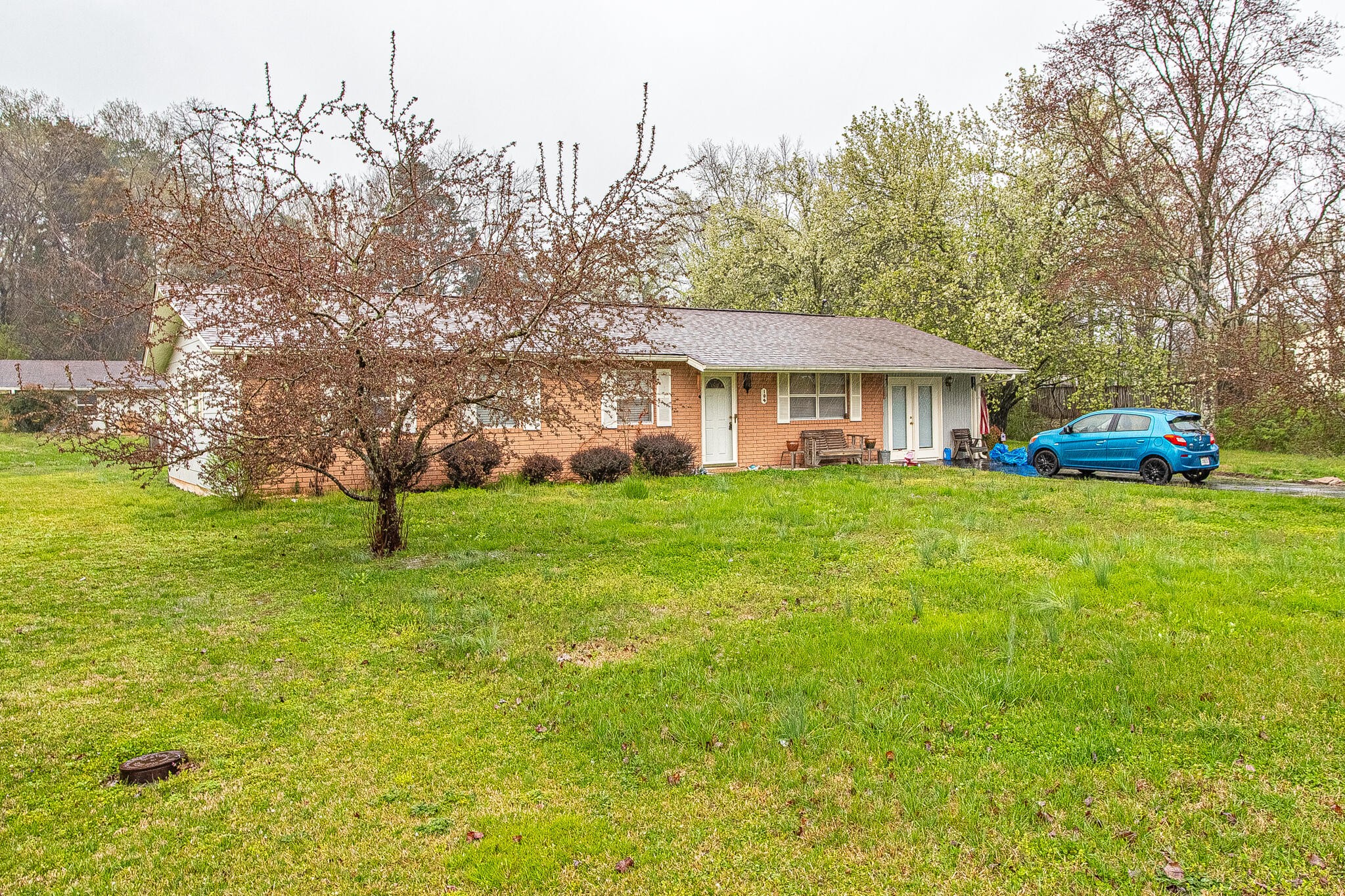 104 West Lincoln Road Oak Ridge, TN 37830 - Photo 2 of 30 a front view of a house with garden and trees