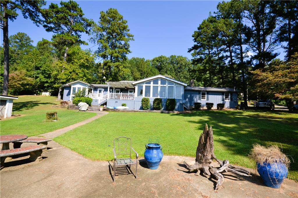 871 Seabreeze Lake Road Buchanan, GA 30113 - Photo 1 of 1 a view of a house with a yard porch and sitting area