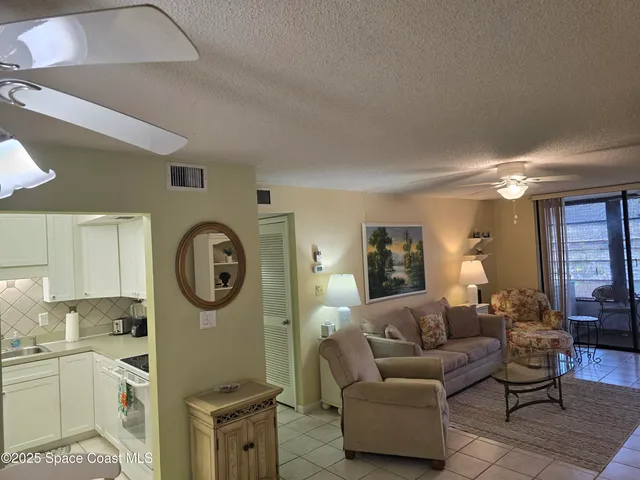 a living room with furniture a clock and a window