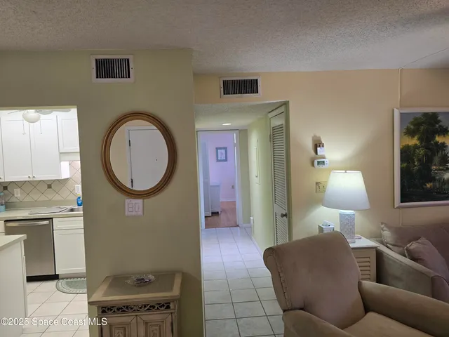 a living room with furniture and a mirror