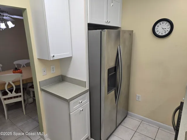 a kitchen with a refrigerator and a table in it