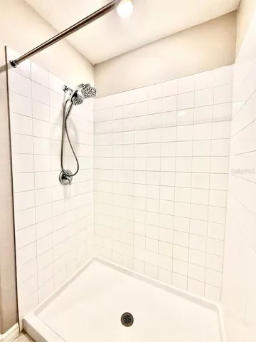 a white toilet sitting next to a white wall