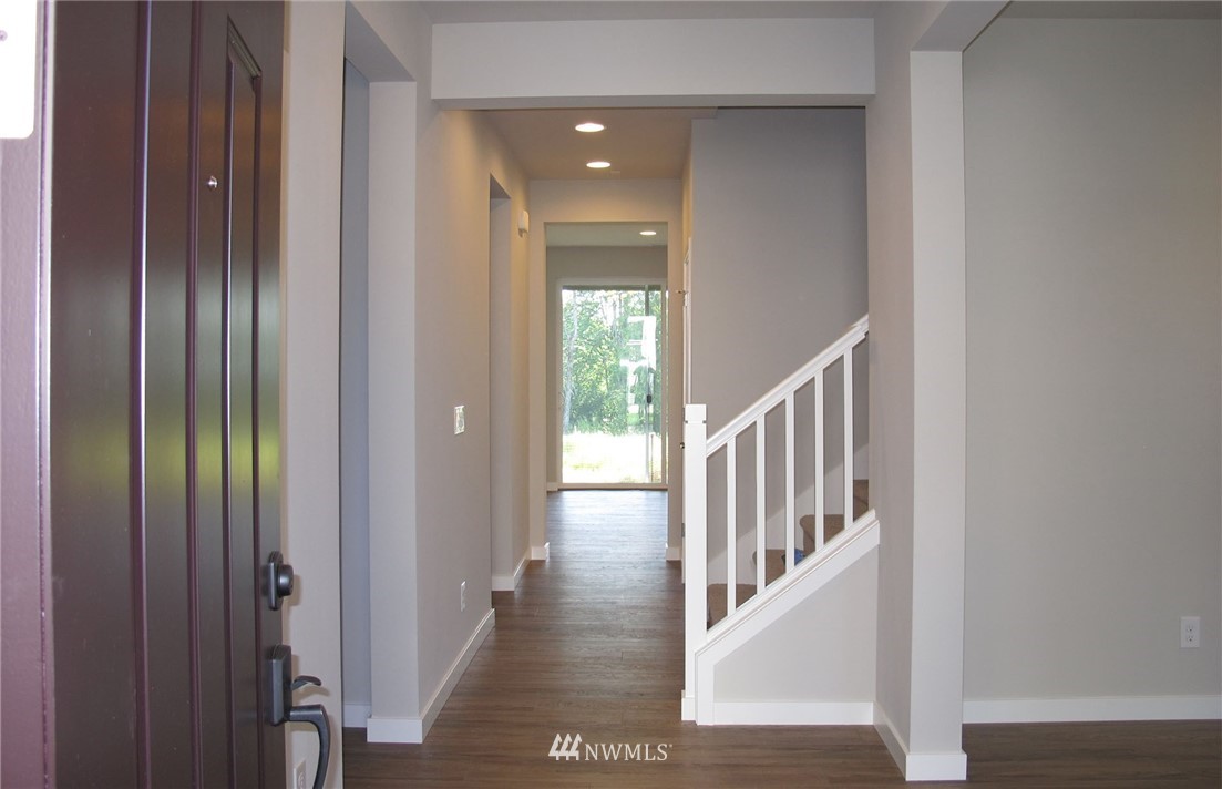 112 215th Street Southeast Bothell, WA 98021 - Photo 4 of 8 a view of an entryway with wooden floor and windows