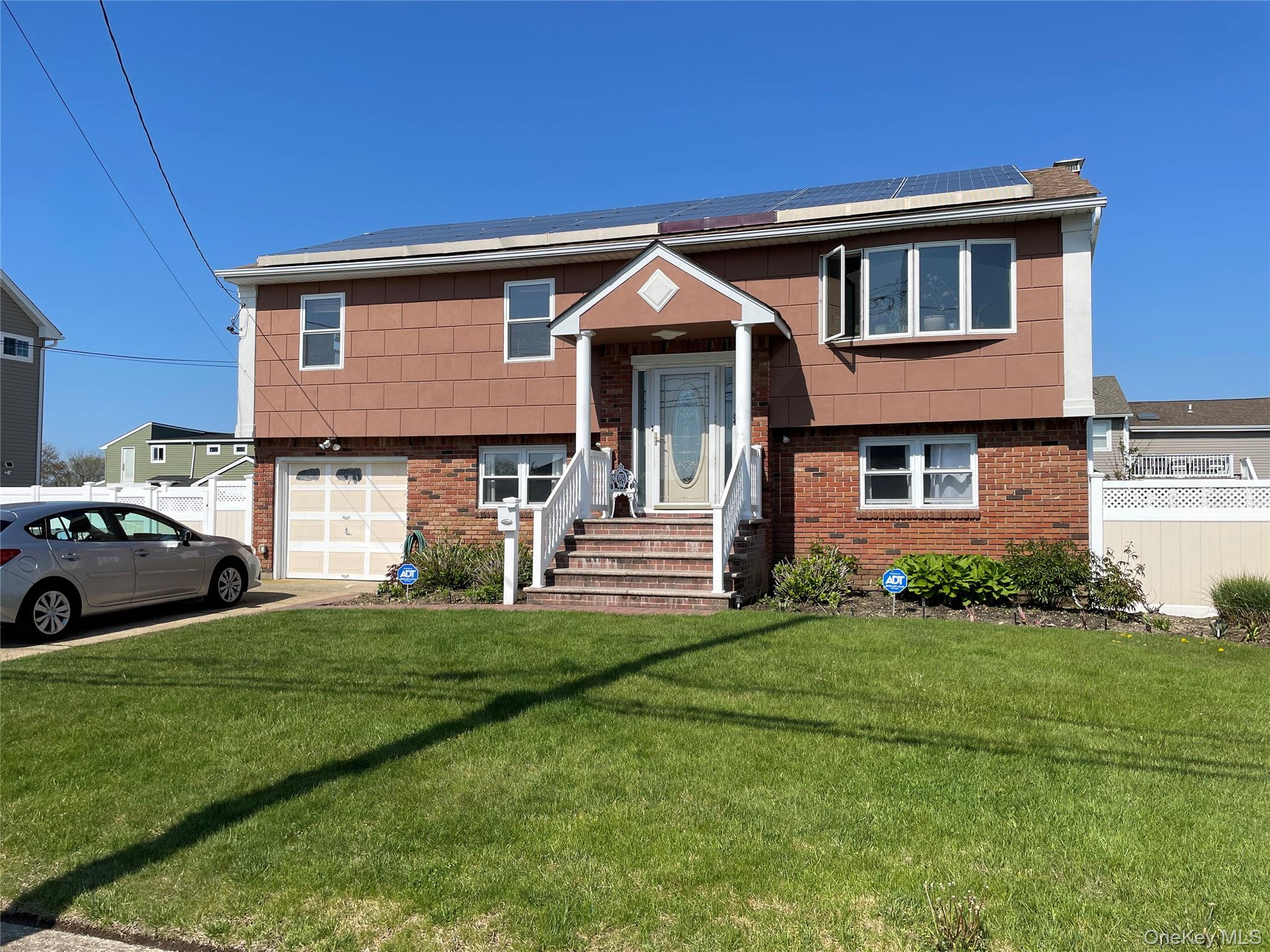 84 Surf Road Lindenhurst, NY 11757 - Photo 1 of 31 a front view of a house with a yard