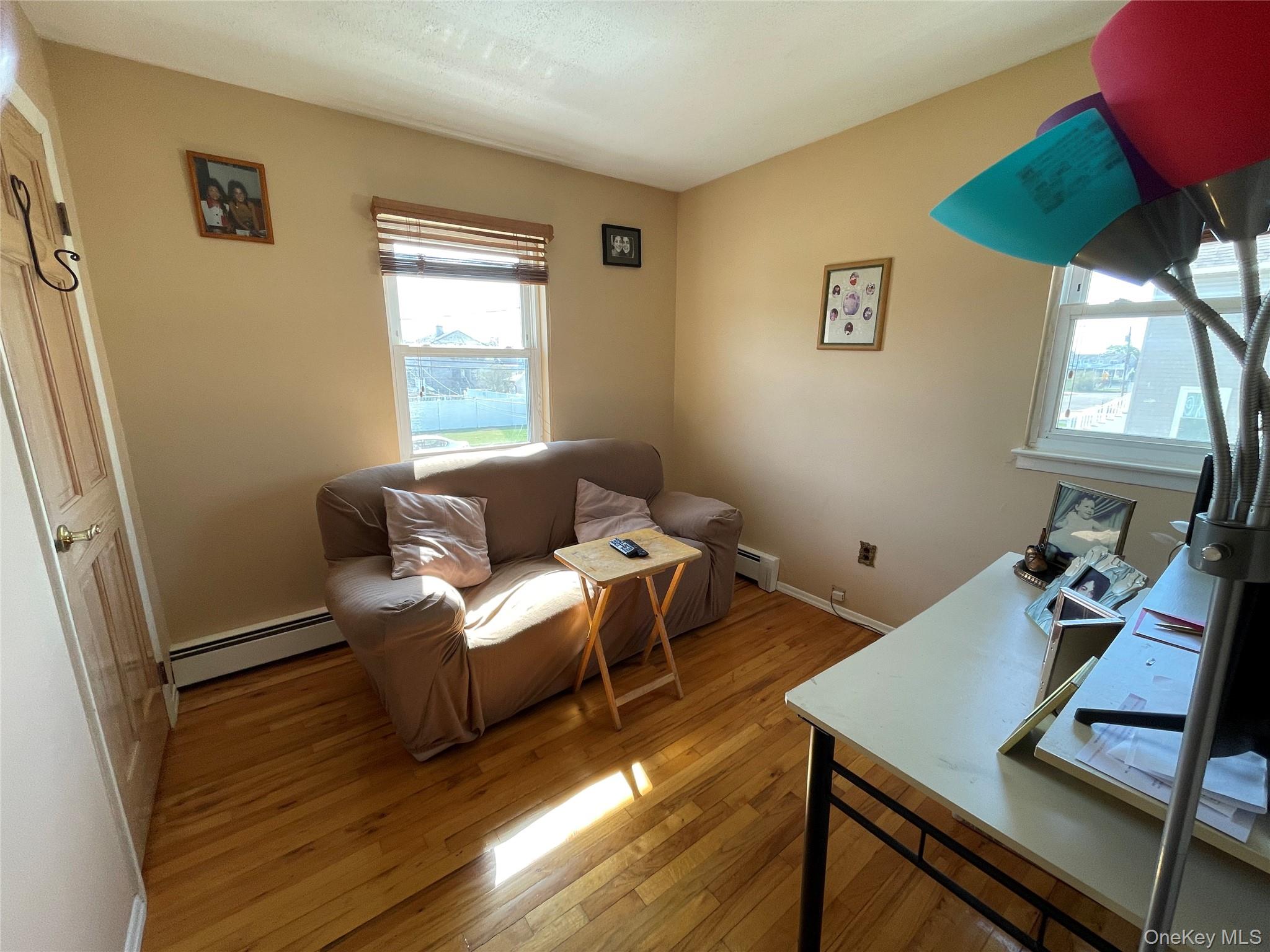 84 Surf Road Lindenhurst, NY 11757 - Photo 12 of 31 a living room with furniture and a window
