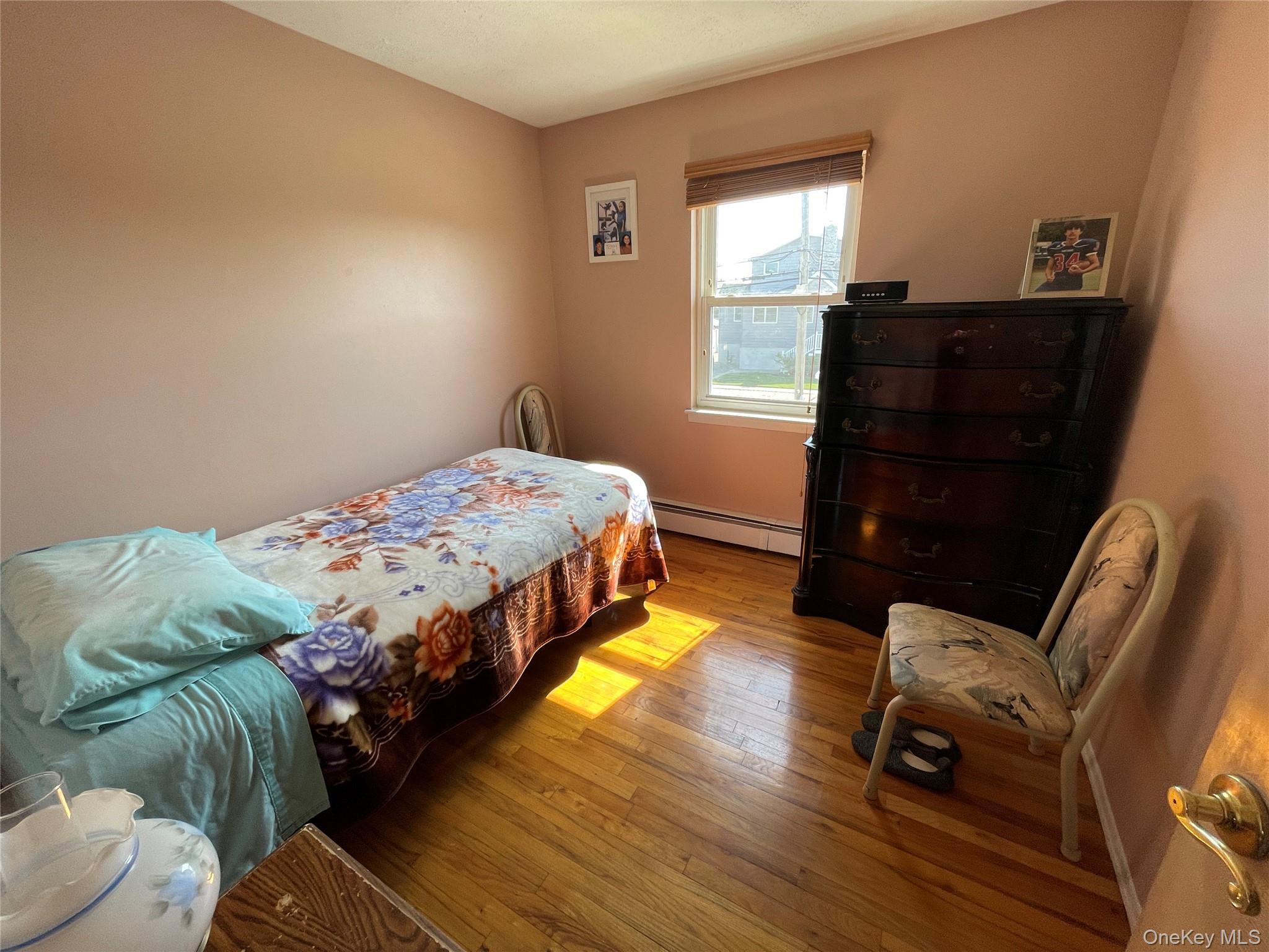 84 Surf Road Lindenhurst, NY 11757 - Photo 13 of 31 a bedroom with a bed and window