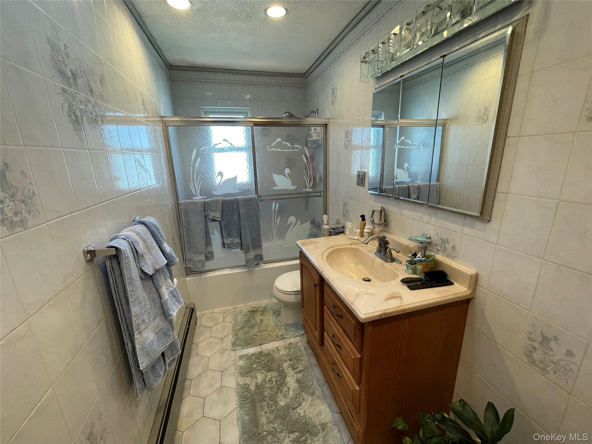 84 Surf Road Lindenhurst, NY 11757 - Photo 14 of 31 a bathroom with a sink toilet and mirror
