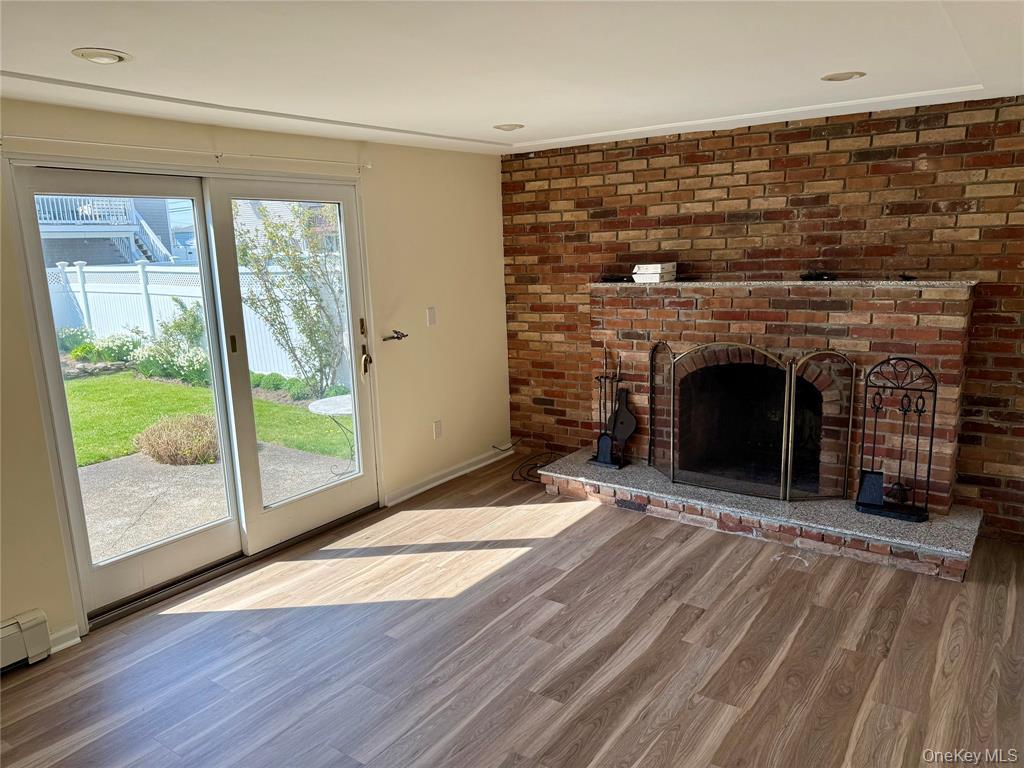 84 Surf Road Lindenhurst, NY 11757 - Photo 15 of 31 a view of an empty room with wooden floor and a window