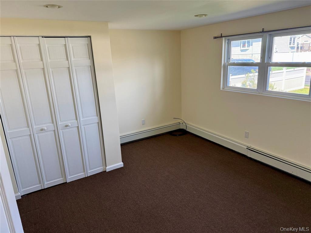 84 Surf Road Lindenhurst, NY 11757 - Photo 20 of 31 an empty room with a window