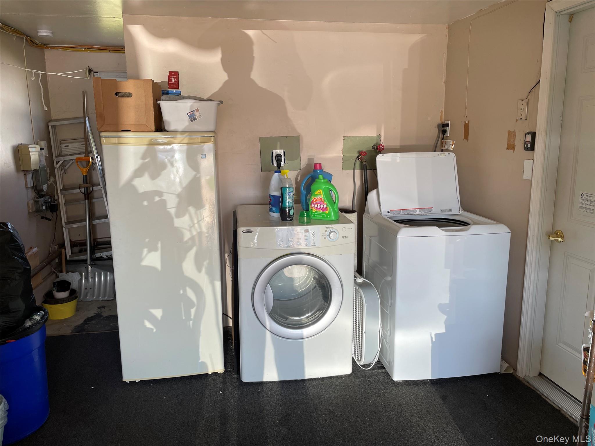 84 Surf Road Lindenhurst, NY 11757 - Photo 22 of 31 a view of a storage and utility room with washer and dryer
