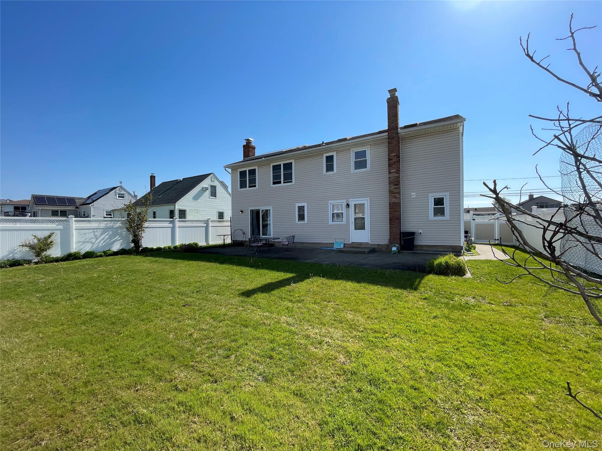 84 Surf Road Lindenhurst, NY 11757 - Photo 26 of 31 a front view of house with yard and swimming pool