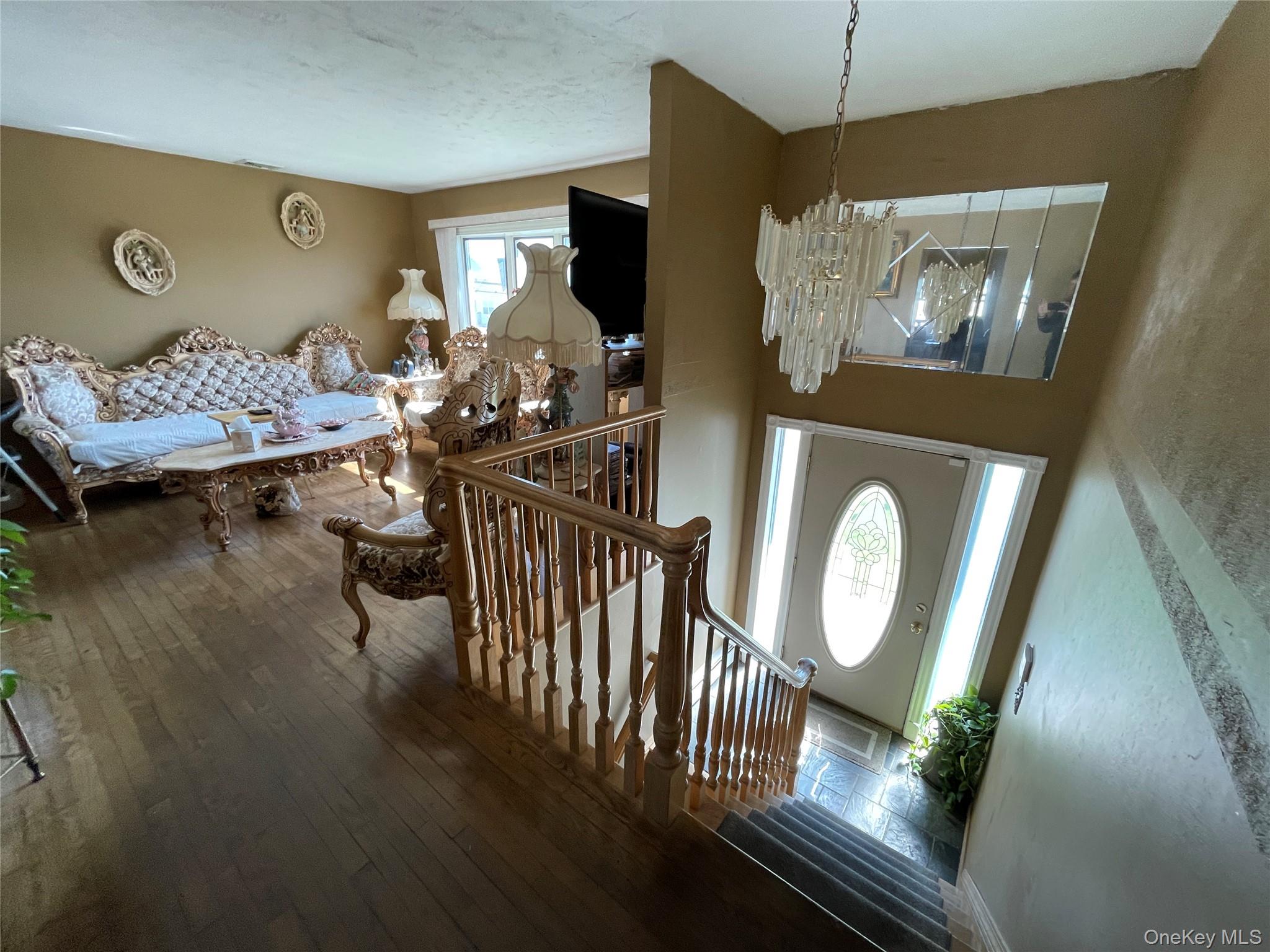 84 Surf Road Lindenhurst, NY 11757 - Photo 3 of 31 a living room with furniture and a chandelier