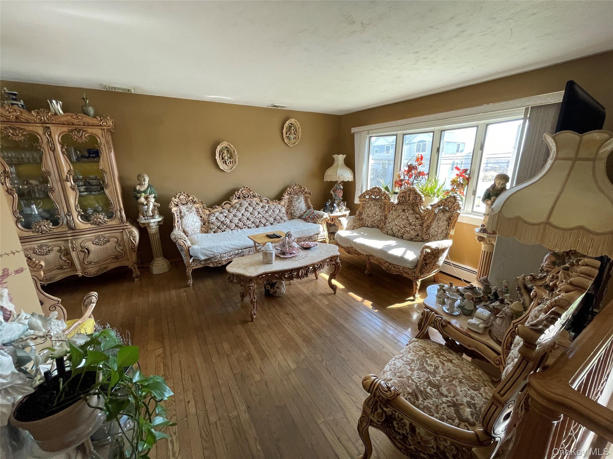 84 Surf Road Lindenhurst, NY 11757 - Photo 4 of 31 a living room with furniture and a couch