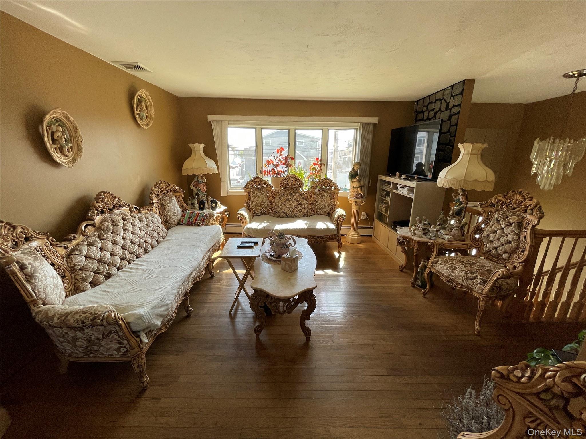84 Surf Road Lindenhurst, NY 11757 - Photo 5 of 31 a living room with furniture and a large window