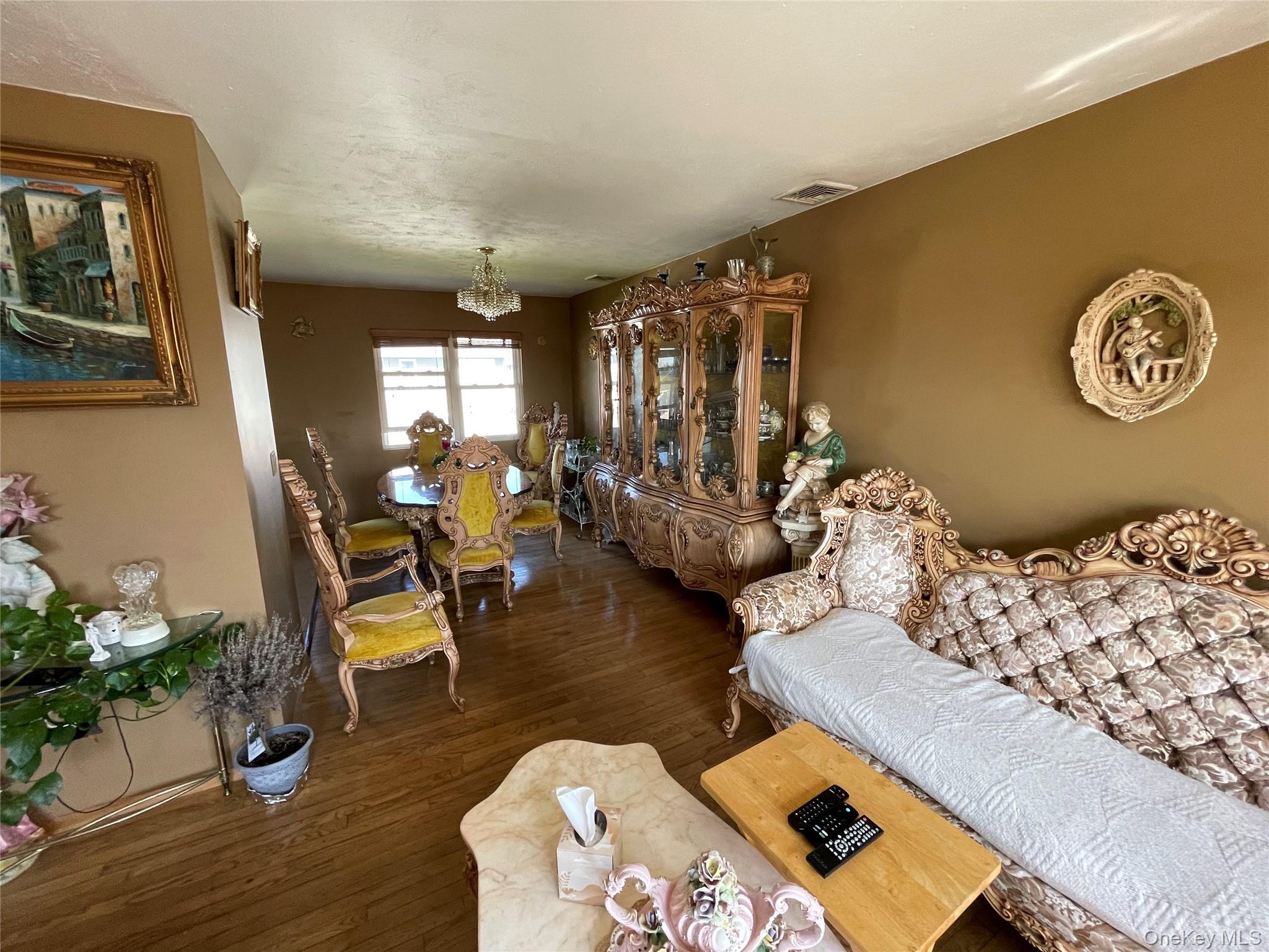 84 Surf Road Lindenhurst, NY 11757 - Photo 6 of 31 a living room with furniture and a wooden floor