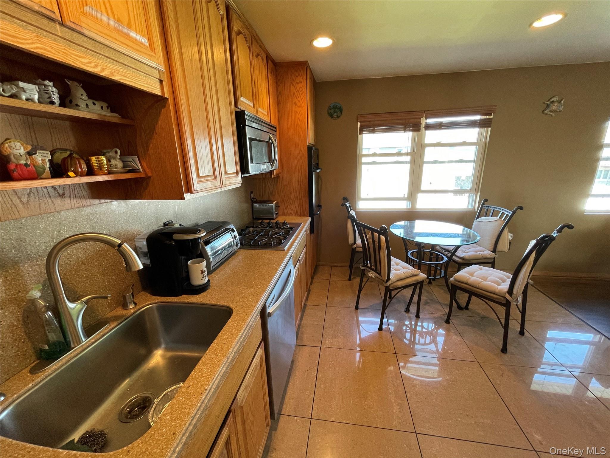 84 Surf Road Lindenhurst, NY 11757 - Photo 8 of 31 a kitchen with a table chairs and a sink