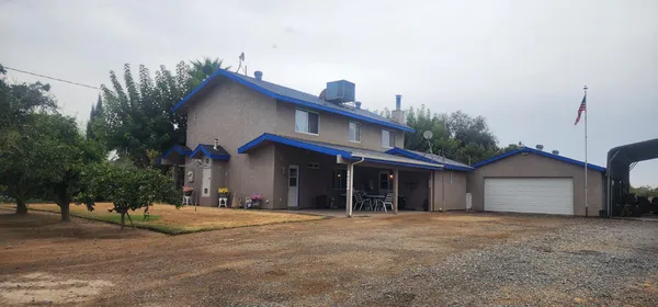 a view of a house with a yard and garage