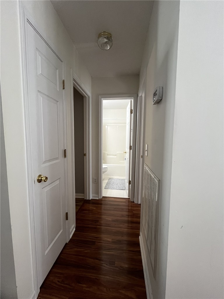 116 Arbors Court Central, SC 29630 - Photo 20 of 27 A well-lit hallway with gleaming wood flooring leads to a conveniently placed bathroom.