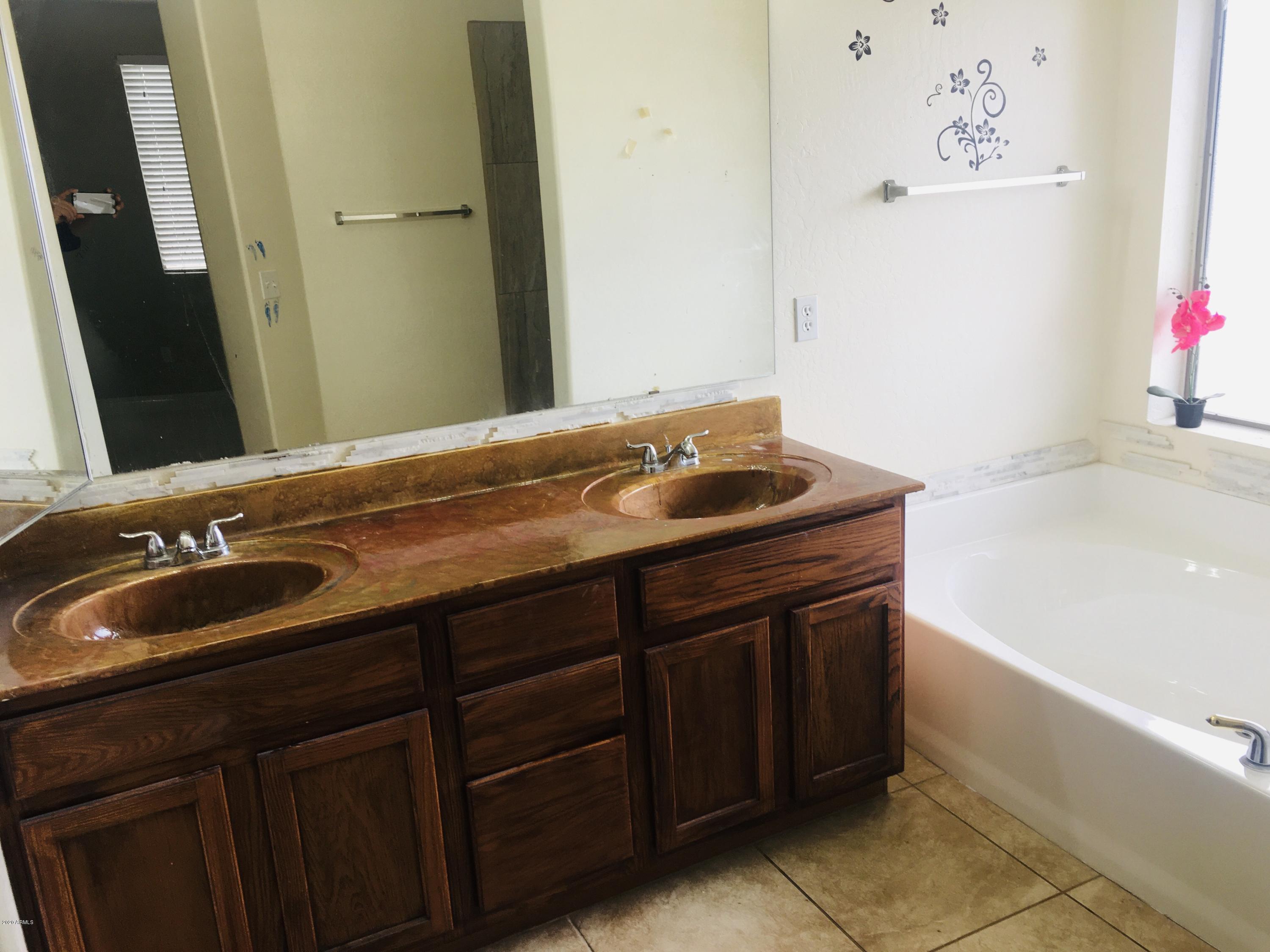 2743 West Lamar Road Phoenix, AZ 85017 - Photo 5 of 12 a bathroom with a sink and a mirror
