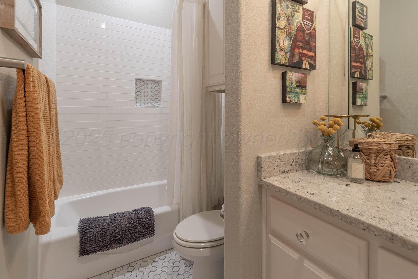 6809 Baccus Amarillo, TX 79124 - Photo 16 of 20 a bathroom with a granite countertop sink a toilet and shower
