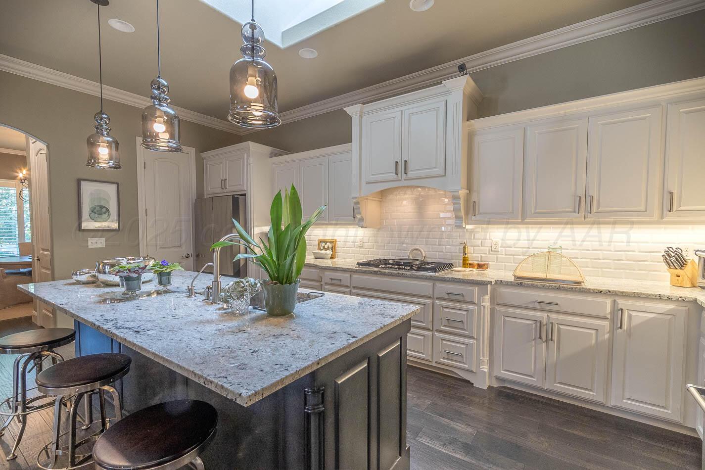 6809 Baccus Amarillo, TX 79124 - Photo 3 of 20 a kitchen with a table chairs stove and cabinets