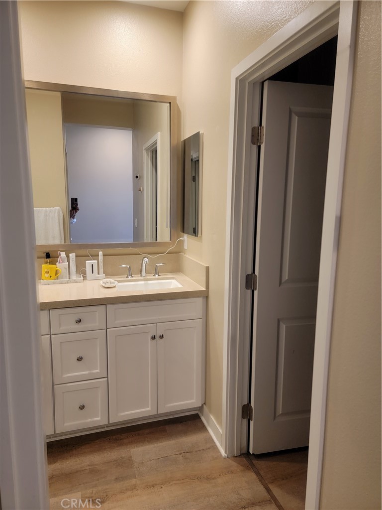 8014 Ackerman Street Buena Park, CA 90621 - Photo 11 of 16 a spacious bathroom with a granite countertop sink and a mirror