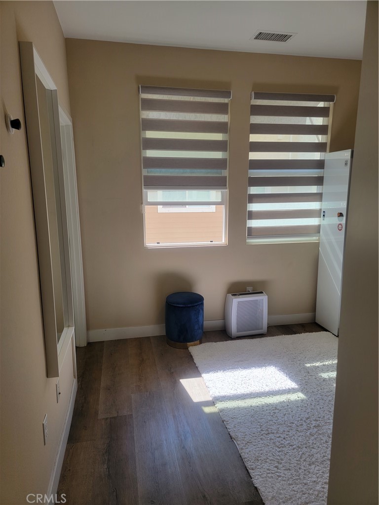 8014 Ackerman Street Buena Park, CA 90621 - Photo 13 of 16 a view of an empty room with wooden floor and a window