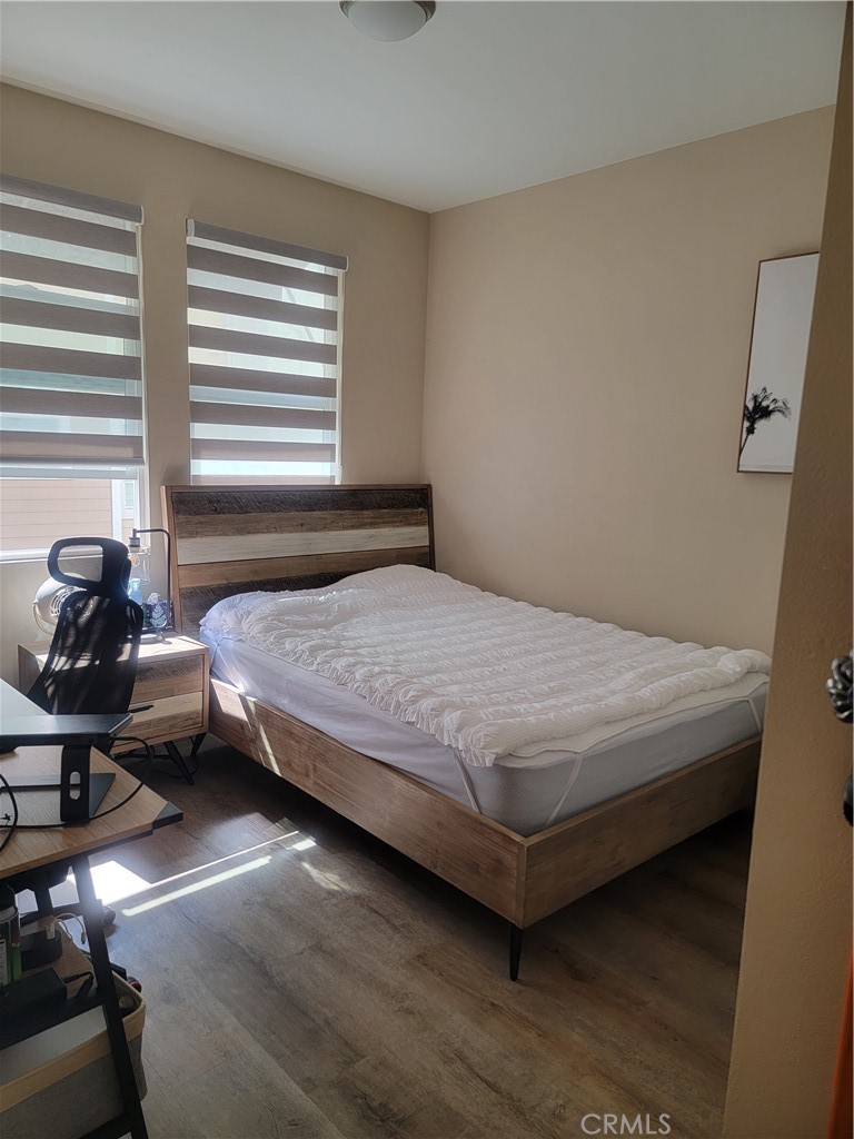 8014 Ackerman Street Buena Park, CA 90621 - Photo 7 of 16 a bedroom with a bed and wooden floor