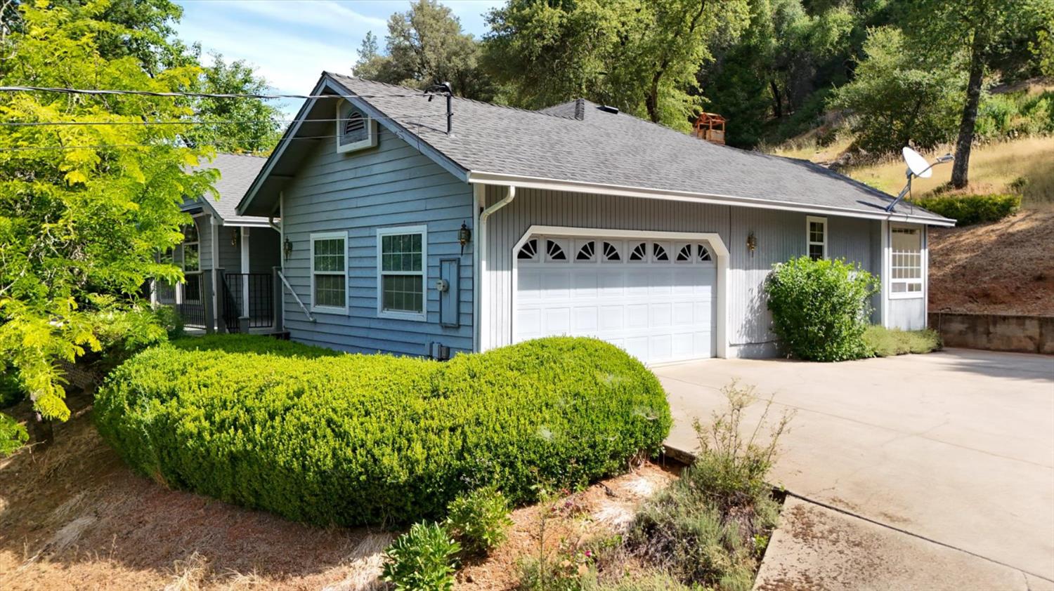 16479 Brewer Road Grass Valley, CA 95949 - Photo 1 of 33 a view of a house with a yard plants and large tree