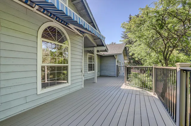 a view of backyard with large window and wooden floor