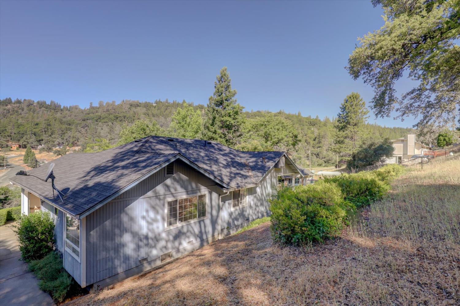 16479 Brewer Road Grass Valley, CA 95949 - Photo 27 of 33 a view of a house with a yard and mountain in the background