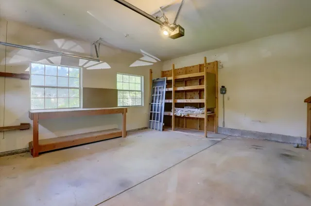 a view of an empty room with furniture and racks on the wall