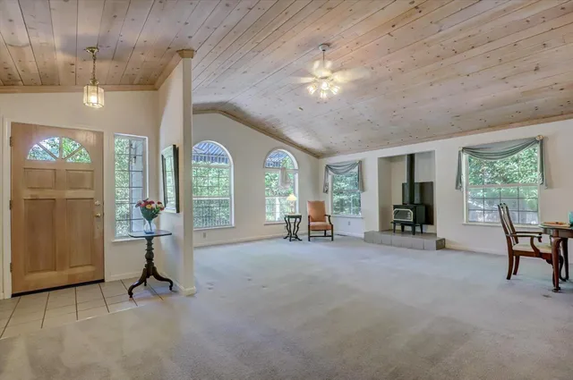 a view of a livingroom with furniture a fireplace and window