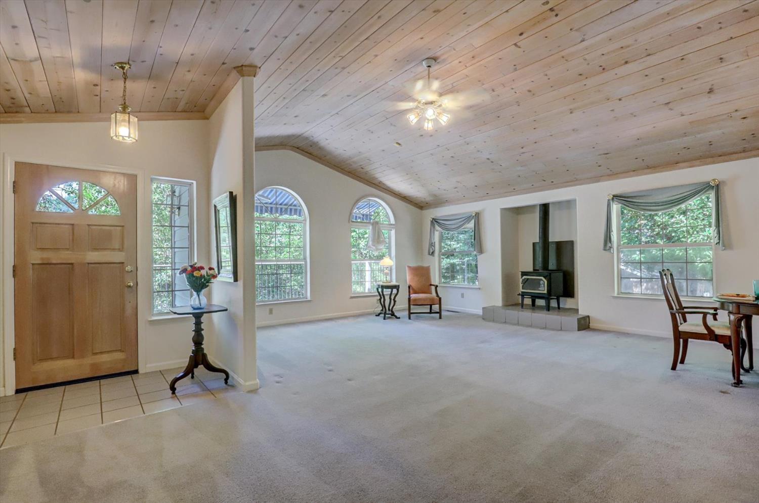 16479 Brewer Road Grass Valley, CA 95949 - Photo 7 of 33 a view of a livingroom with furniture a fireplace and window