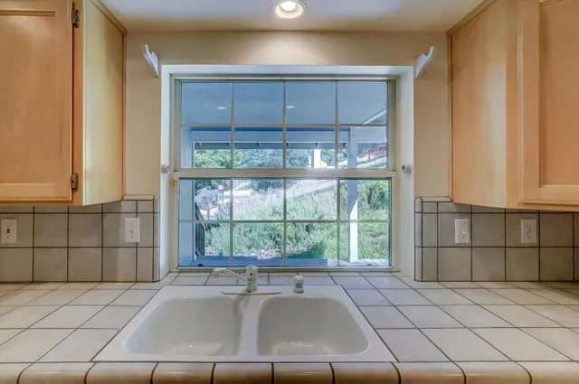a kitchen with a sink and large window