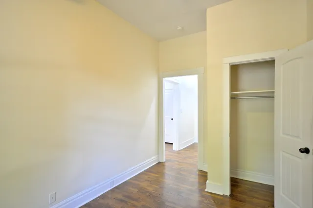 a view of a room with wooden floor