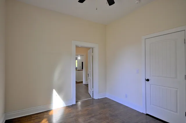a view of empty room with wooden floor