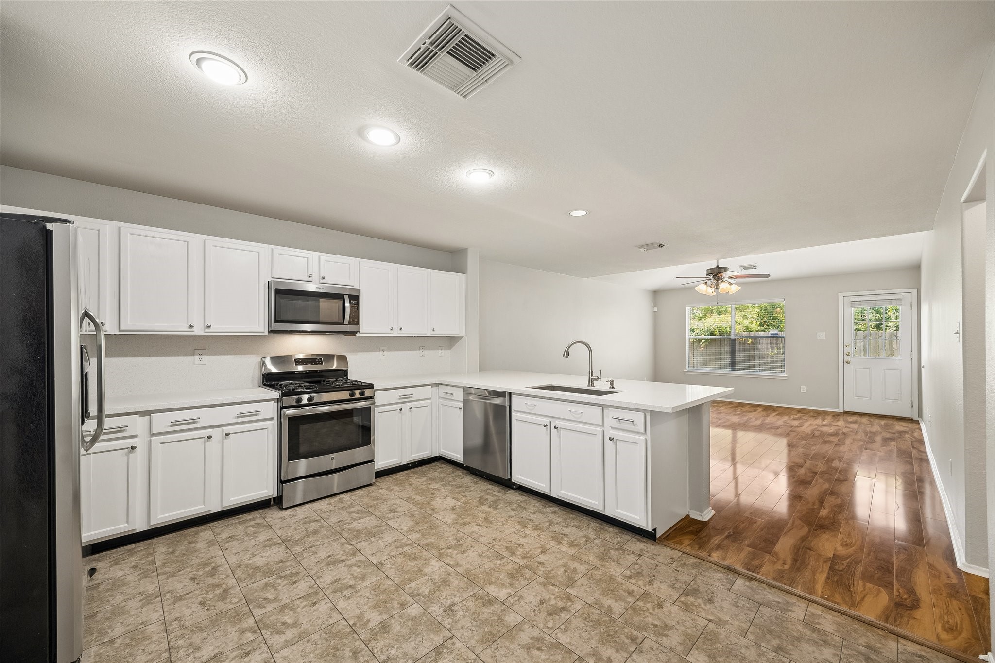 223 Sunset Colony Drive Rosharon, TX 77583 - Photo 8 of 50 This kitchen keeps everything within easy reach, with plenty of counter space, stainless-steel appliances, crisp white cabinetry and an open connection to both casual and formal areas that makes everyday life and entertaining feel effortless.