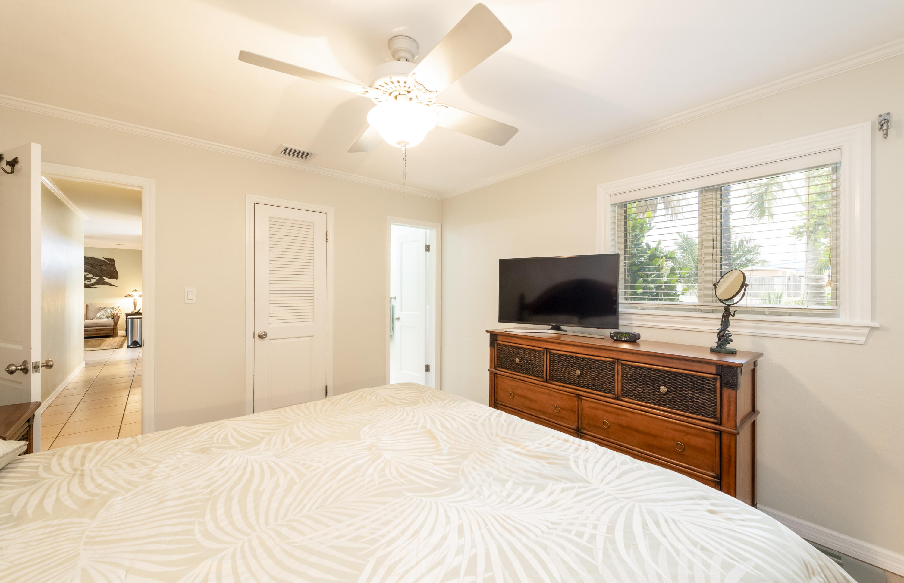 14 Bamboo Terrace Key Haven, FL 33040 - Photo 13 of 32 a bedroom with a bed and a flat screen tv