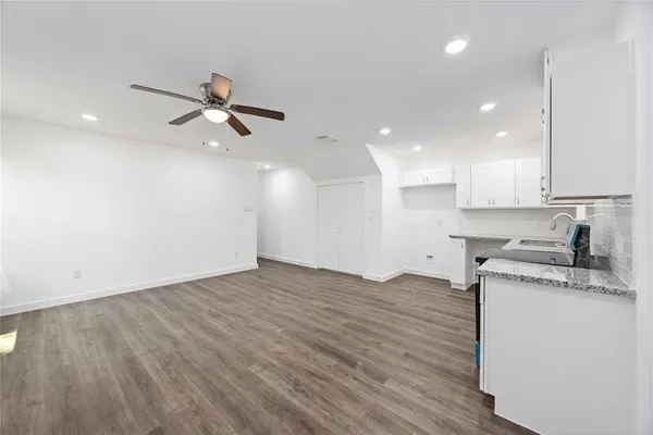 a view of a kitchen with sink and wooden floor