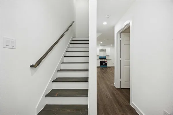 a view of entryway and hall with wooden floor